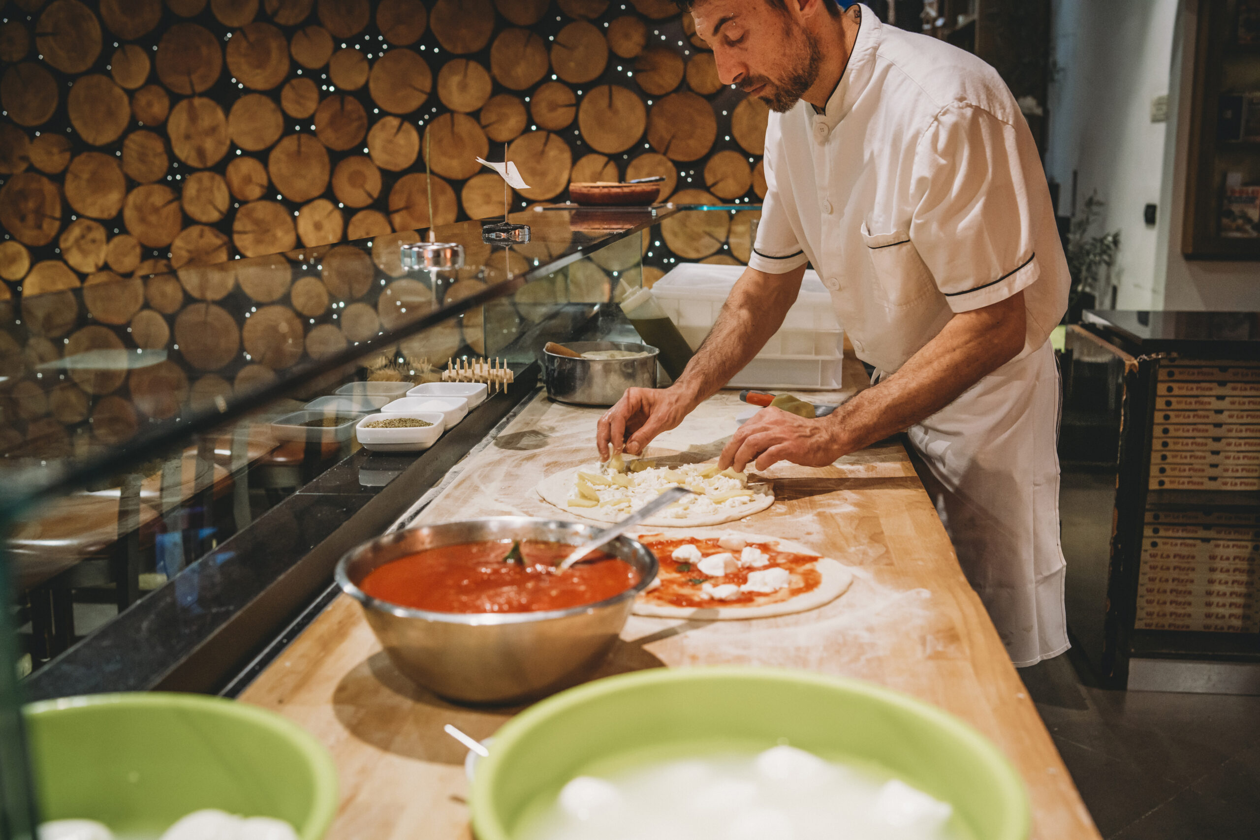 Pizza chef preparing a pizza at the restaurant